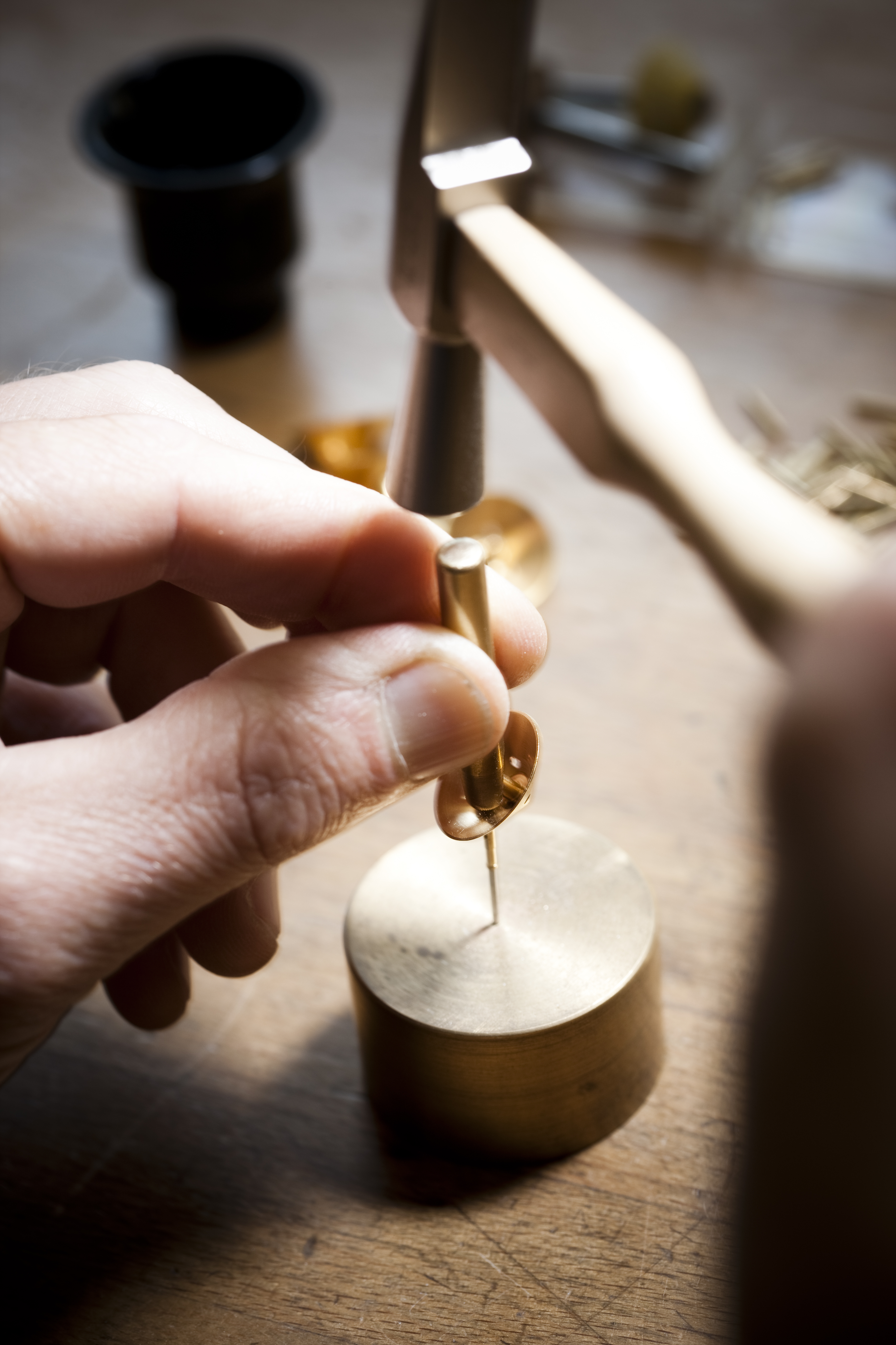 Brass, wood, a hammer.